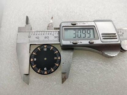 Ghost Omega 31mm watch dial with green luminescent markers, compatible with NH35/NH36, for enhanced legibility.