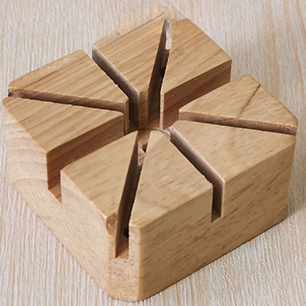 Wooden watch band holder with strap pin remover tool for precise watch repair and adjustment.