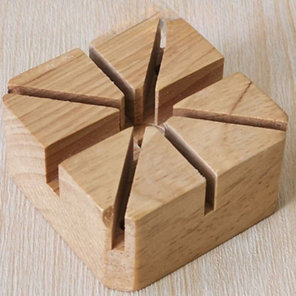 Wooden watch band holder with strap pin remover tool for precise watch repair and adjustment.
