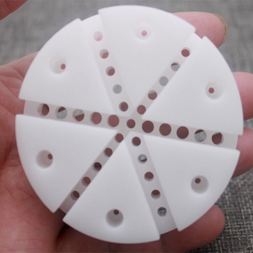 Round white watch band holder with pins remover tool for watch strap repair and adjustment.