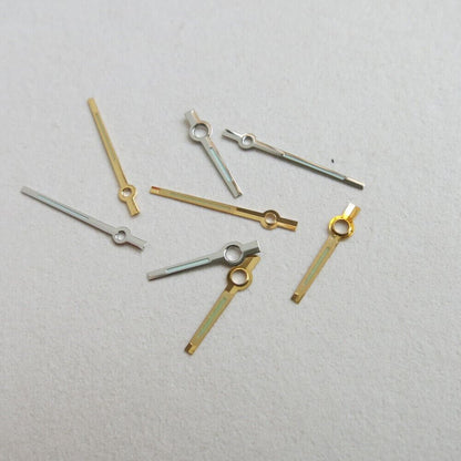Set of 44 luminous watch hands in yellow and white, including hour, minute, and second hands for precise timekeeping.