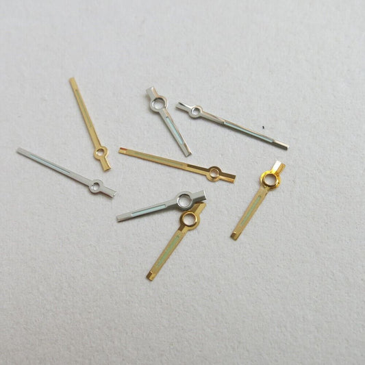 Set of 44 luminous watch hands in yellow and white, including hour, minute, and second hands for precise timekeeping.
