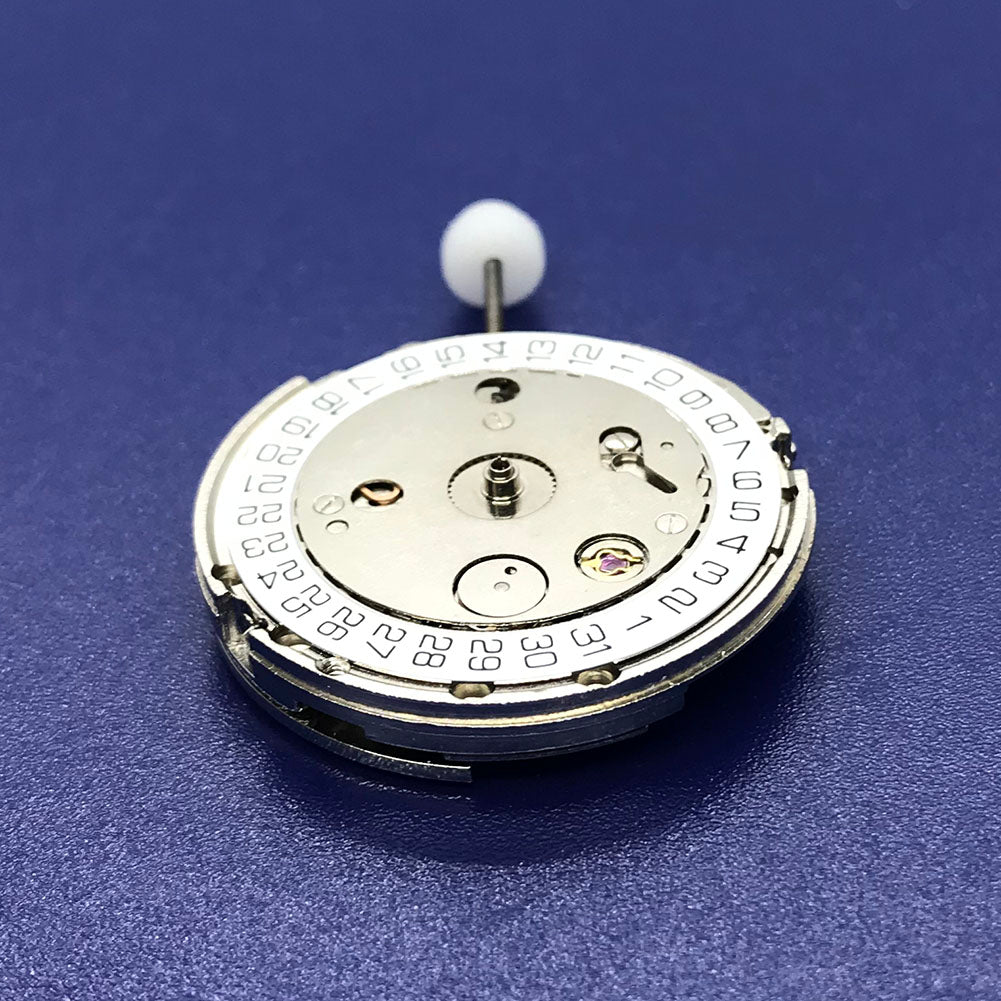 Close-up of Chinese Automatic 4813 watch movement with silver plating and three hands.