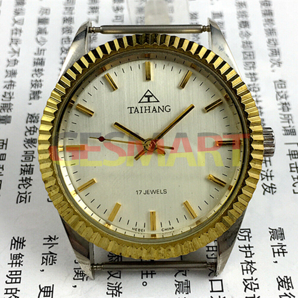 38mm TAIHANG manual mechanical watch with golden nail markers, silver round dial, and 17 jewels movement.