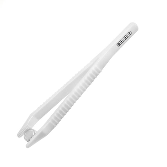 Bergeon 6225 plastic tweezers holding watch batteries for precise accessory handling