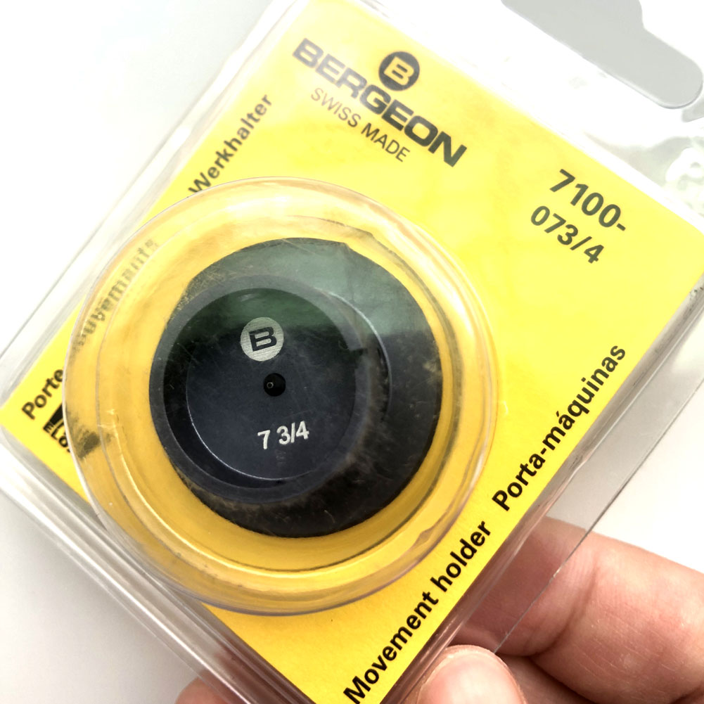Bergeon 7100-07 watch movement holder securing standard watch repair and assembly tools.