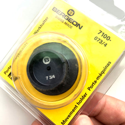 Bergeon 7100-07 watch movement holder securing standard watch repair and assembly tools.