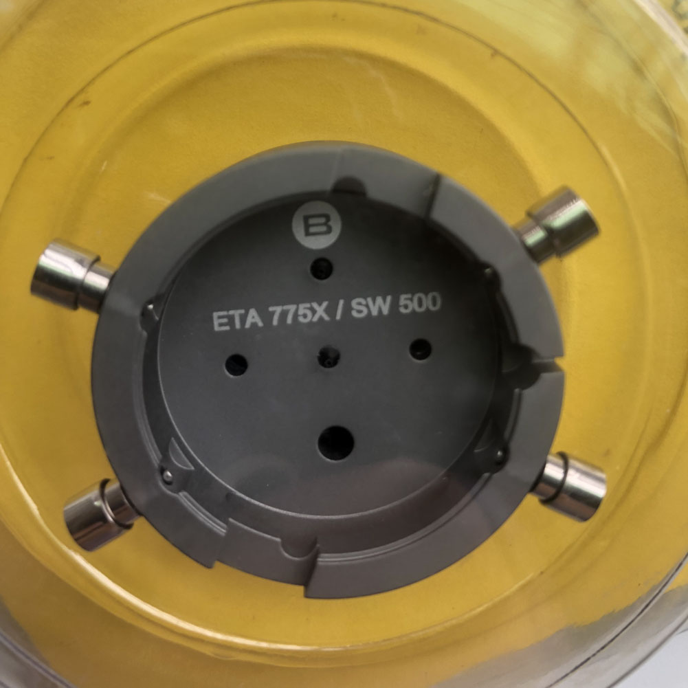 Bergeon 7100 watch movement holder securing ETA 775X Valjoux, precise tool for watch repairs.