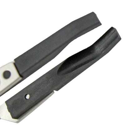 Bergeon 7140 cross locking tweezers gripping watch crystal, precision tool for delicate dial work.
