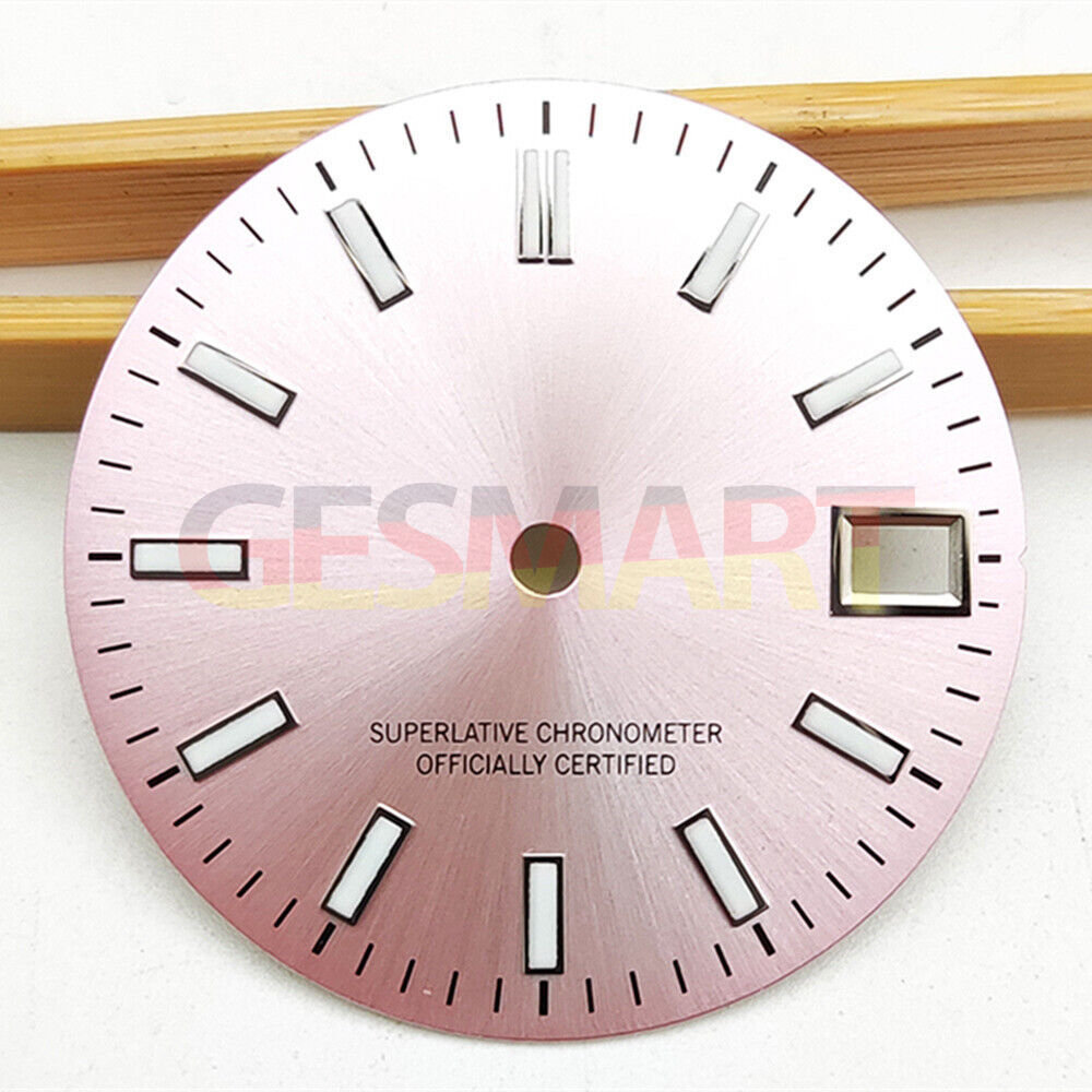 Green luminous polished pink watch dial for NH35 movement, sleek metal design.