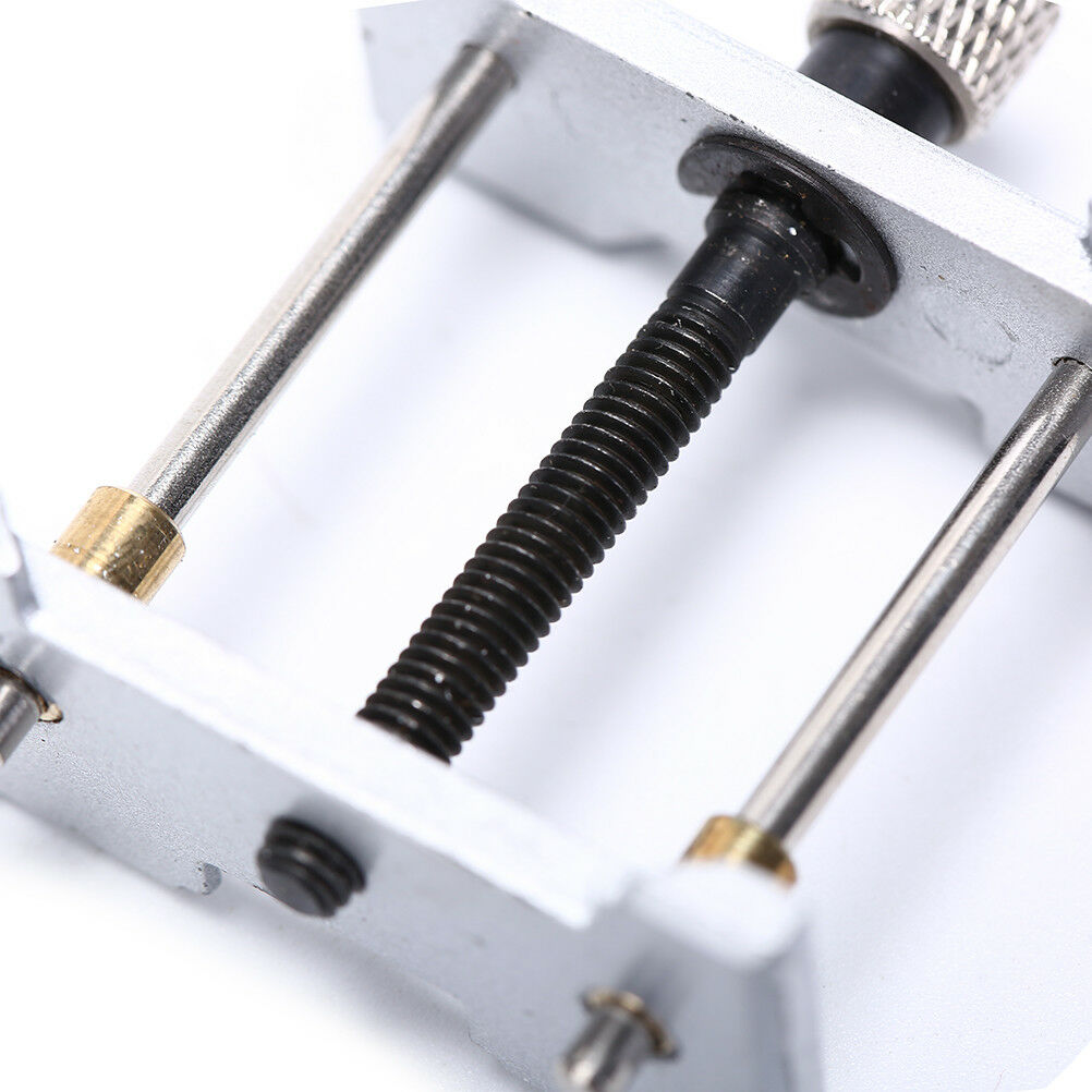 1. Precision metal watch movement holder clamp for secure repairs and adjustments.  