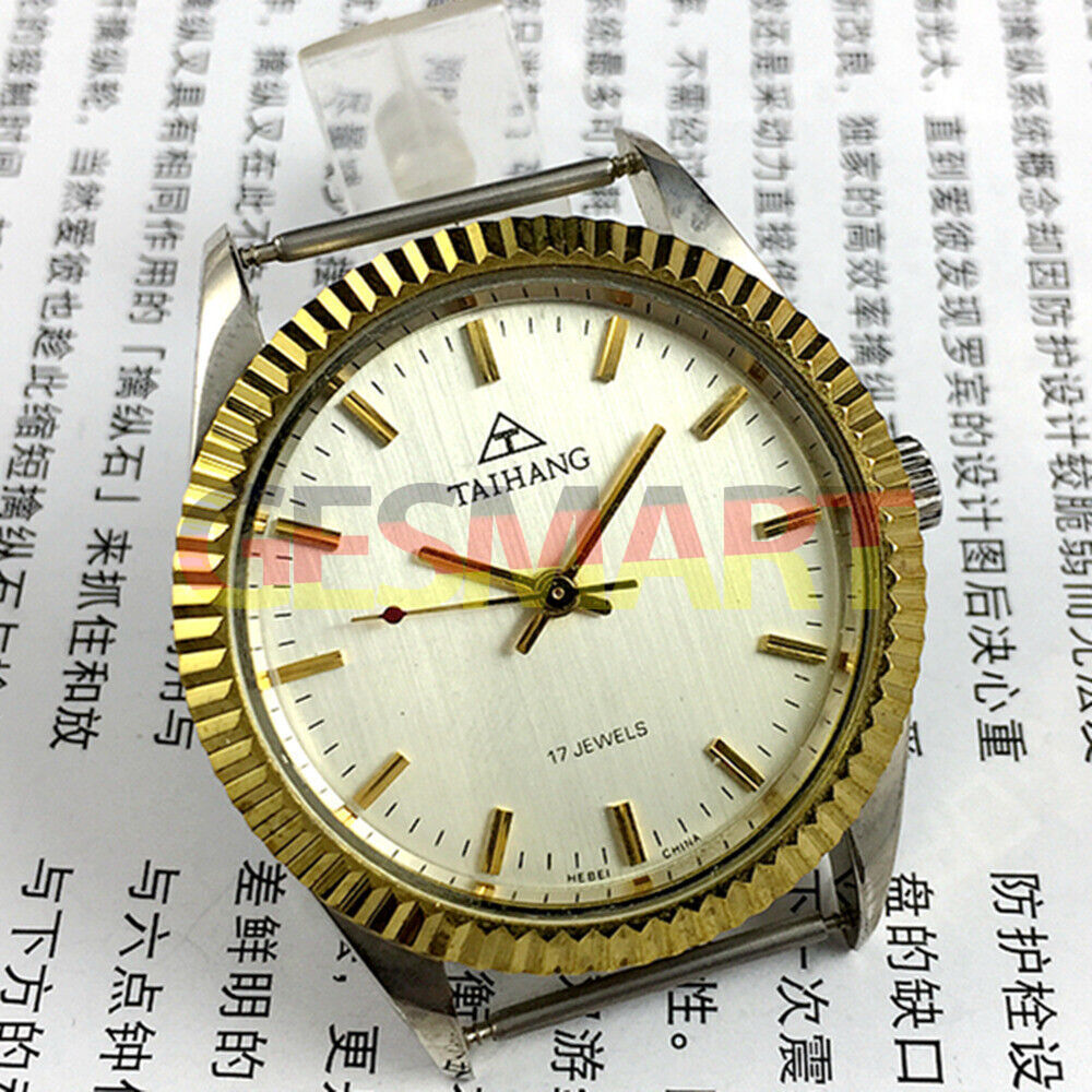 38mm TAIHANG manual mechanical watch with golden nail markers, silver round dial, and 17 jewels movement.