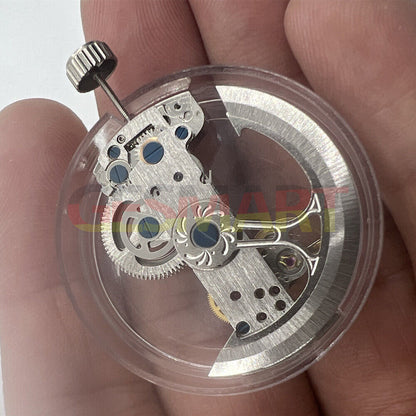 Silver rectangle bare balance wheel watch movement by Asian LG, showcasing intricate automatic mechanical design.