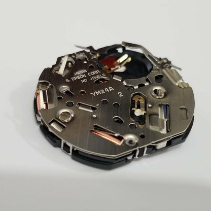 S. Epson YM24 quartz watch movement showing precision gears for accurate timekeeping and repair.