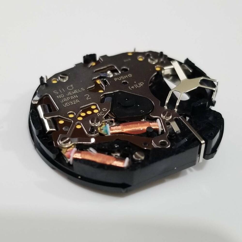 Hattori Epson VD32A quartz watch movement showing precision parts for accurate repairs.