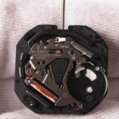 Hattori Epson TMI VX33E quartz watch movement showing precision Japan-made mechanism for watch repairs.